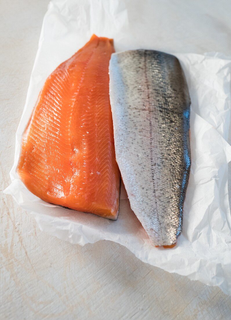 Salmon trout fillets on white paper