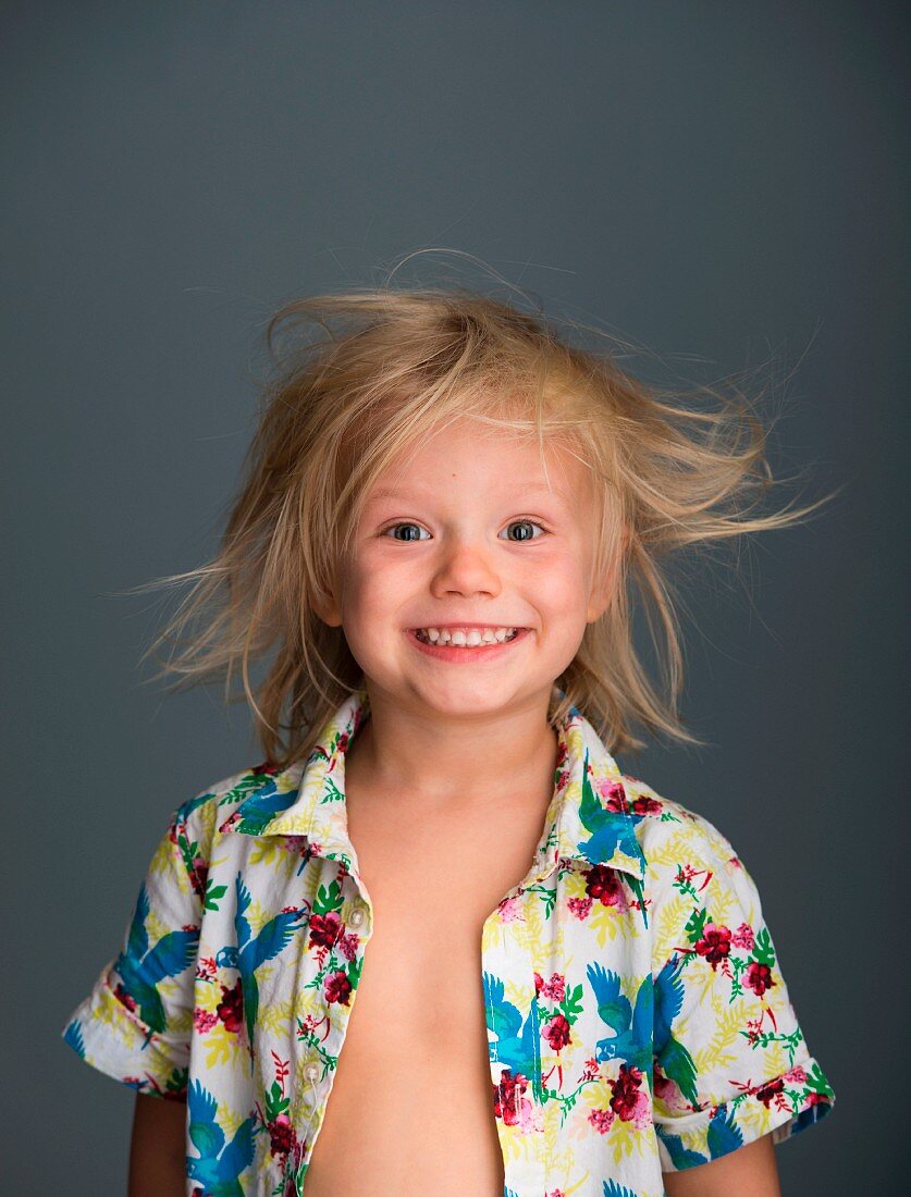 A portrait of a blond boy with tousled hair