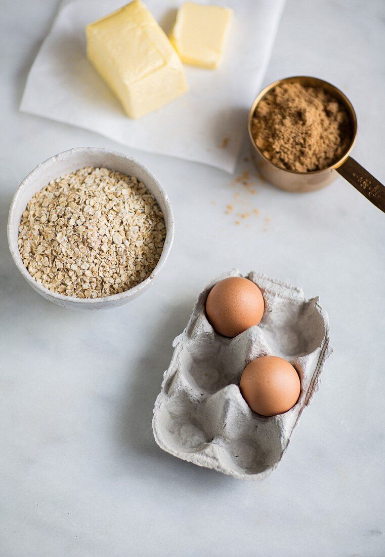 Baking ingredients: butter, oats, eggs and brown sugar