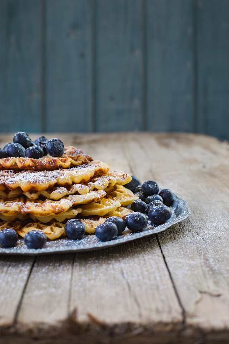 A stack of lemon buttermilk waffles with blueberries