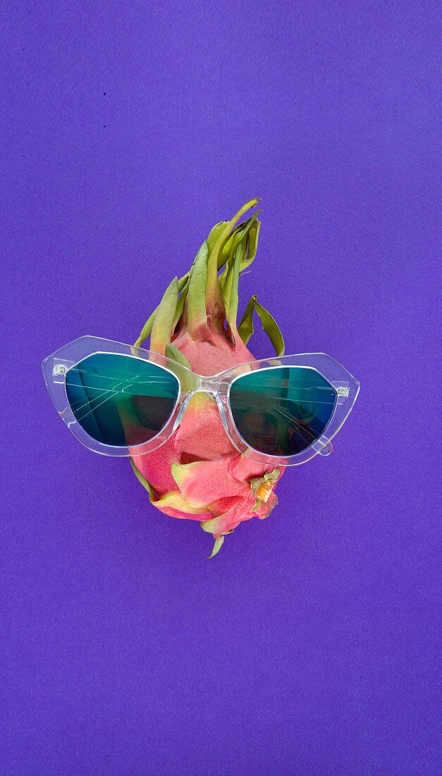 A dragon fruit wearing see-through sunglasses