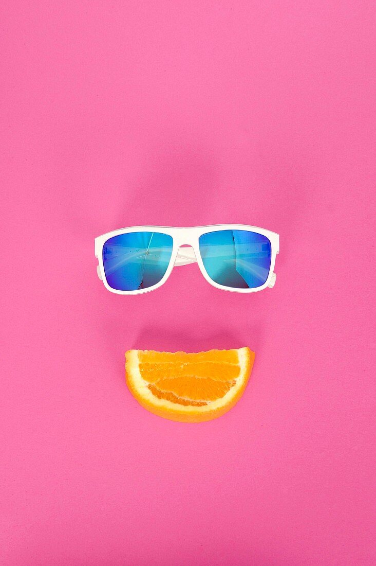 An orange wedge with white sunglasses