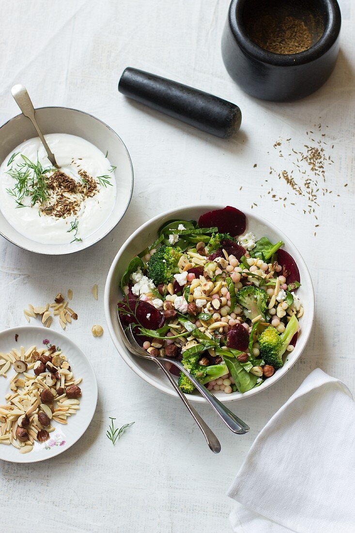 Ptitim salad with broccoli, beetroot, almonds, olives and feta cheese