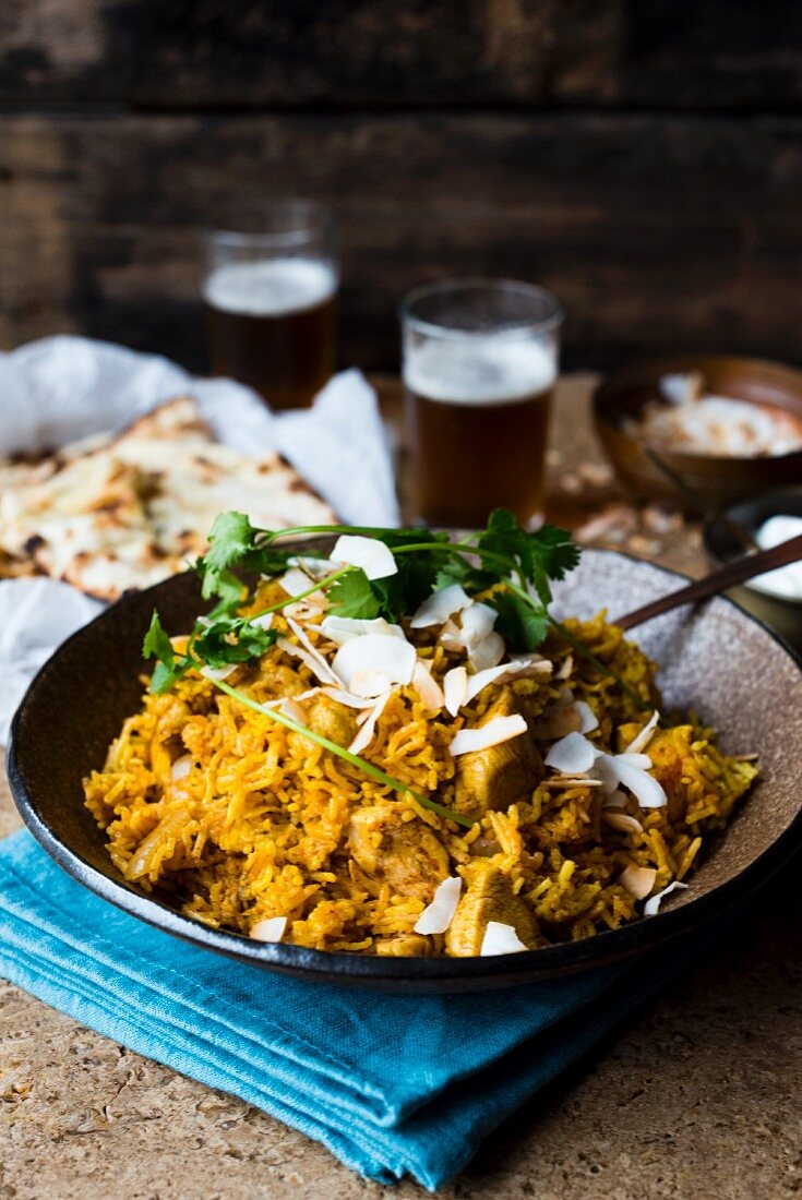 Chicken biryani with coconut flakes and parsley