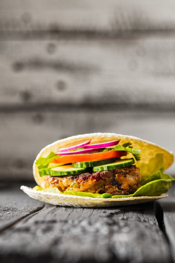 A gluten-free veggie burger in unleavened bread