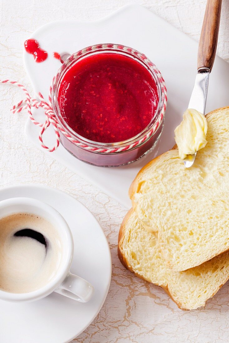 Frühstück mit Espresso, Brioche und Himbeermarmelade