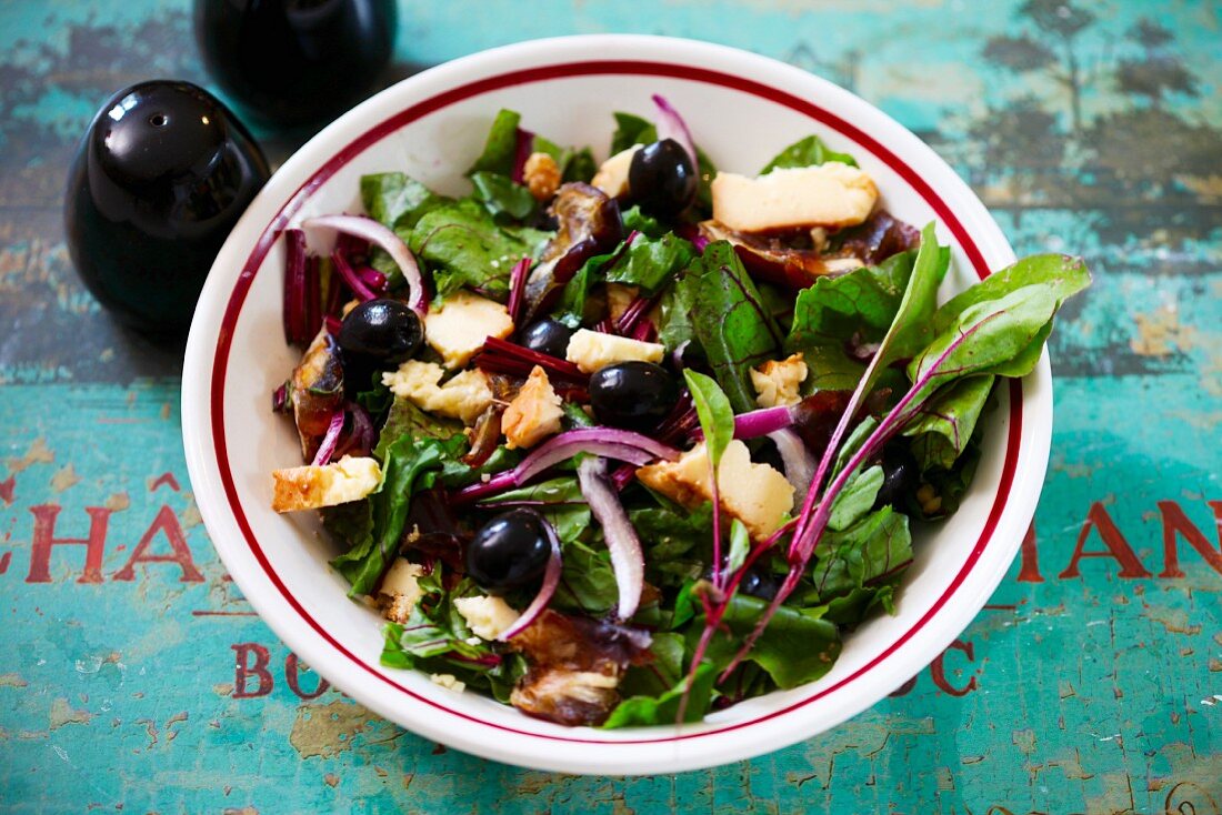 A salad made with beetroot leaves and smoked cheese