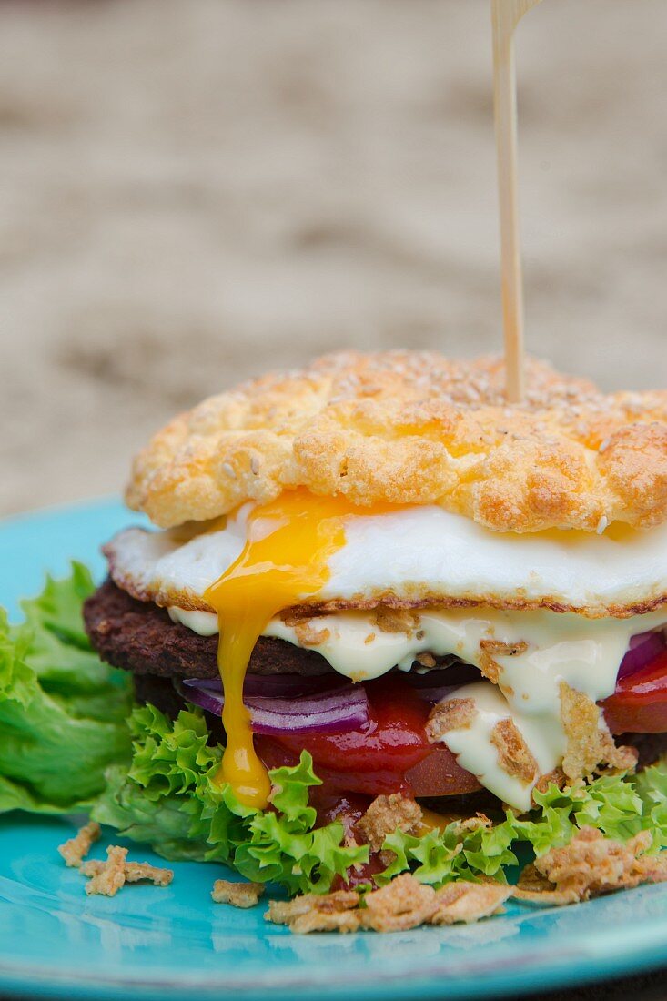 Cloud bread burger with a runny fried egg and roasted onions