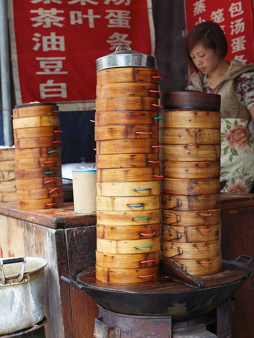 Stacks of bamboo steamers for dim sum at a market (Asia)