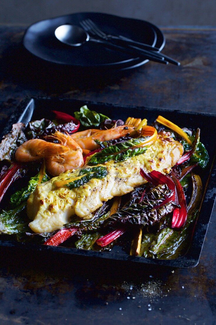 Oven-baked fish gratin with chard and prawns