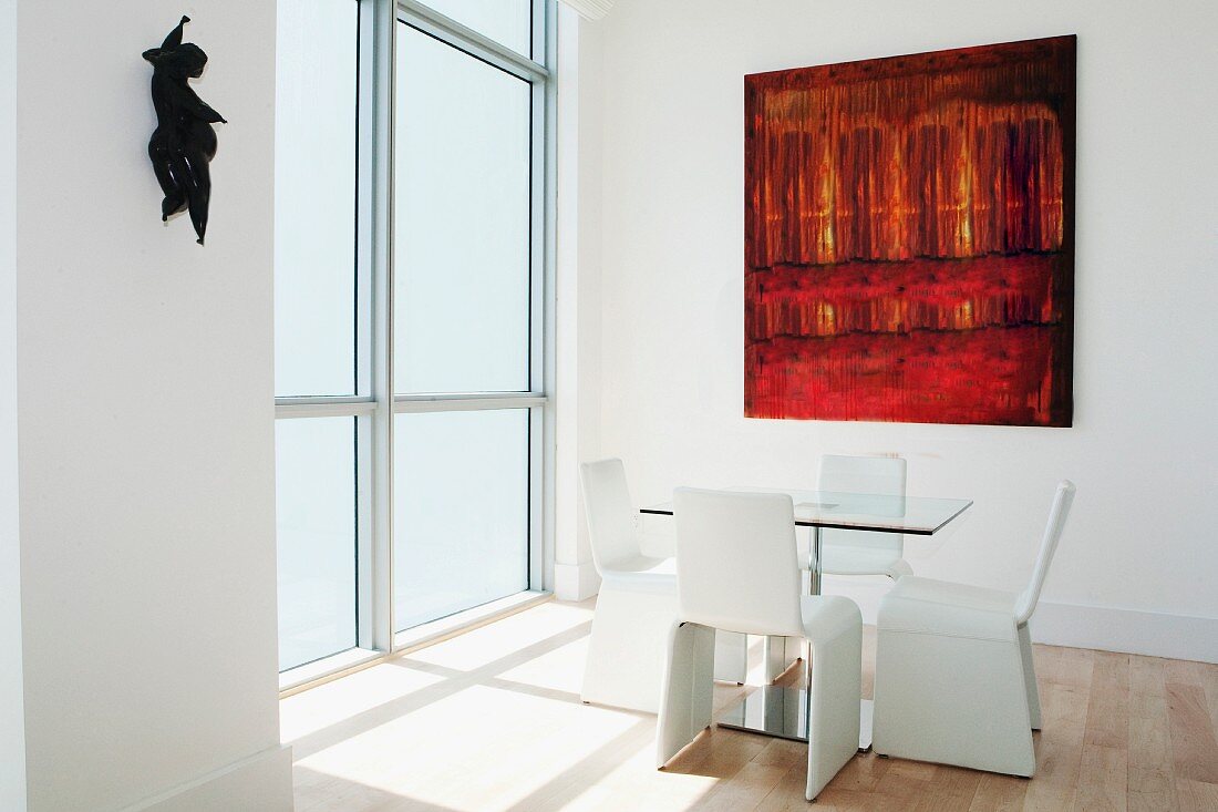 Dining table, chairs and large windows in modern dining room