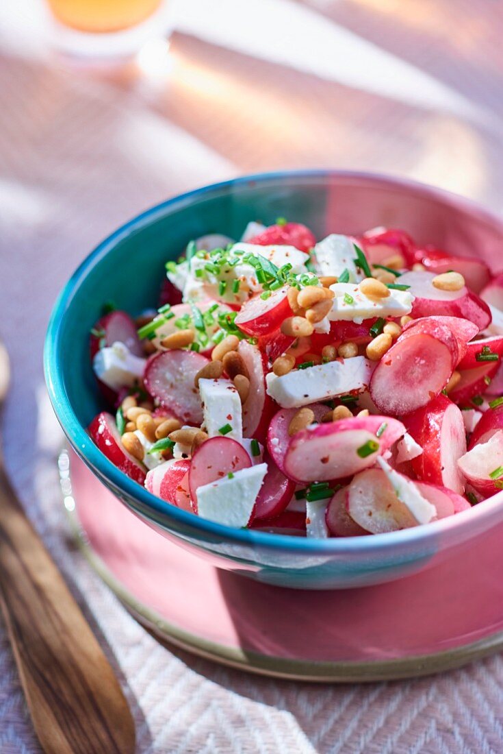 Radish salad with feta cheese and pine nuts