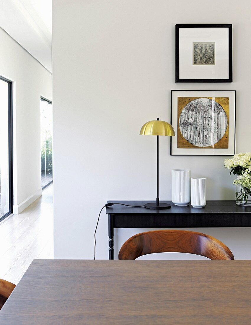 View of console table and pictures seen over dining table