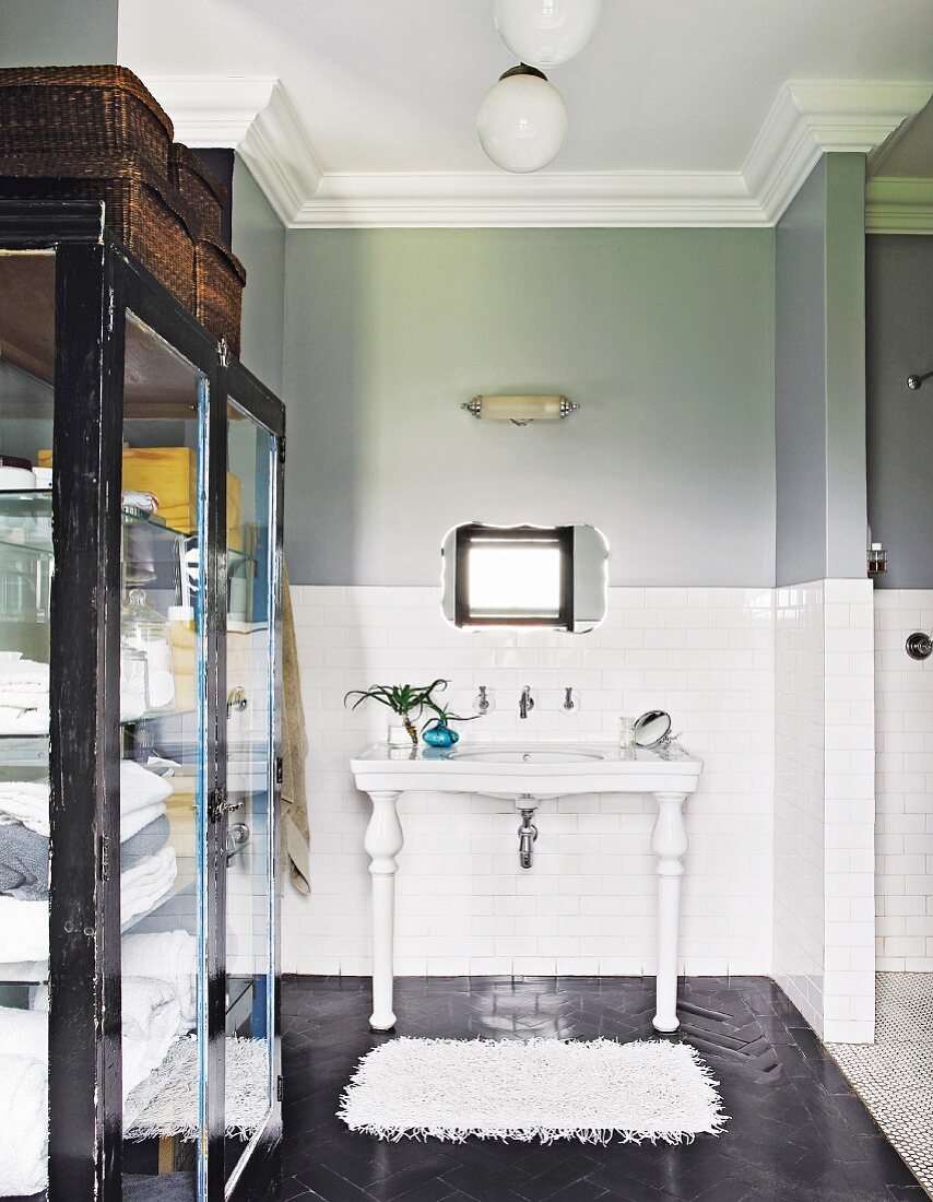 Two-tone wall and cabinet with glass doors in vintage-style bathroom