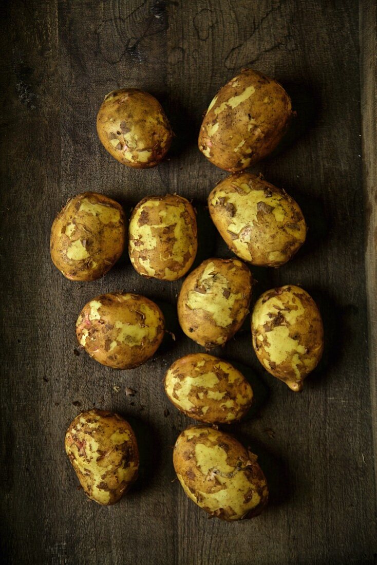 Yukon Gold potatoes on a wooden surface