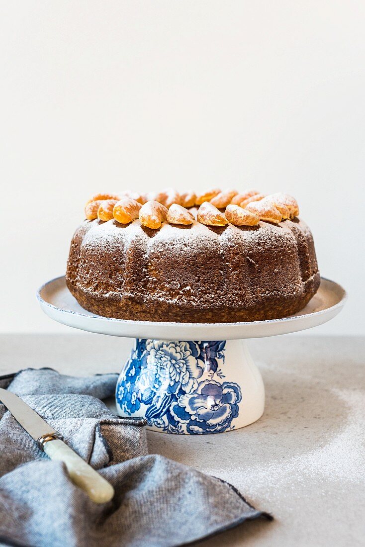 Olive oil Bundt cake with mandarin segments and icing sugar