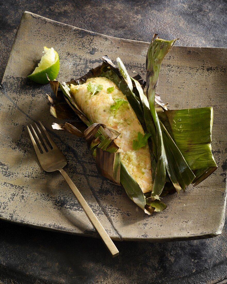Salmon with galangal wrapped in a banana leaf