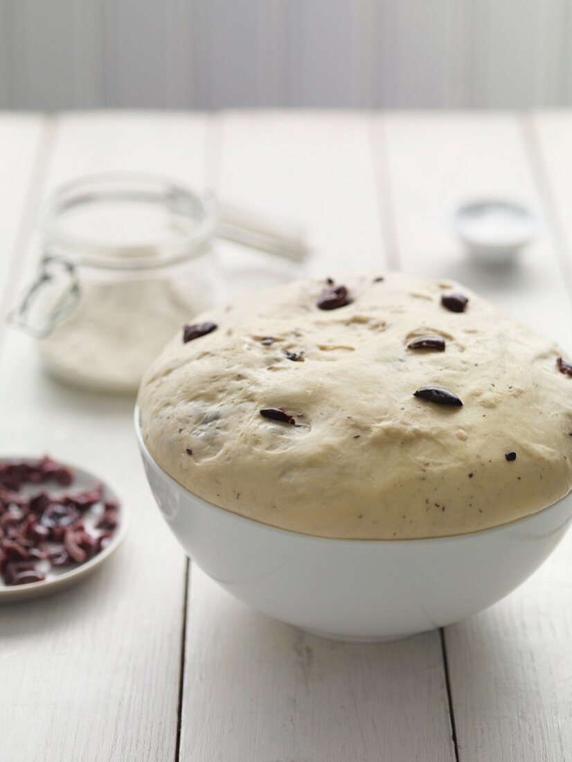 Unbaked olive bread in a bowl
