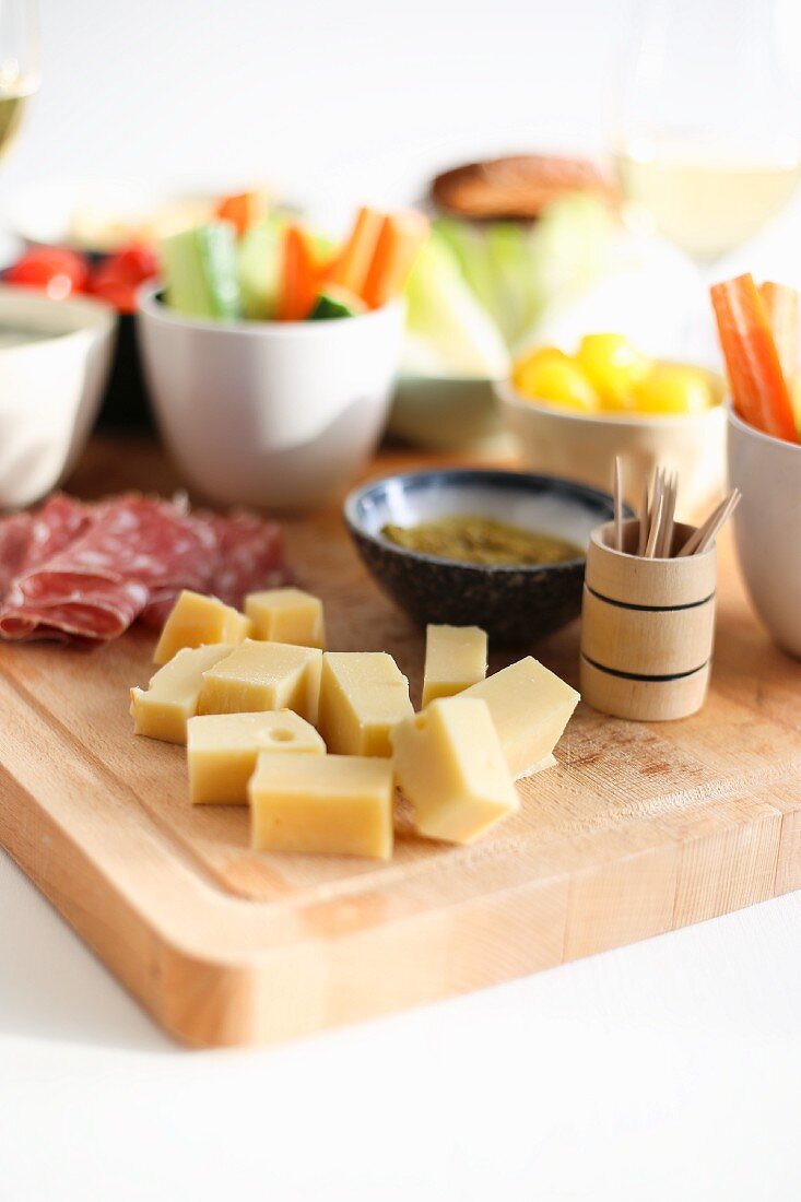 A snack platter with cheese, salami and vegetables