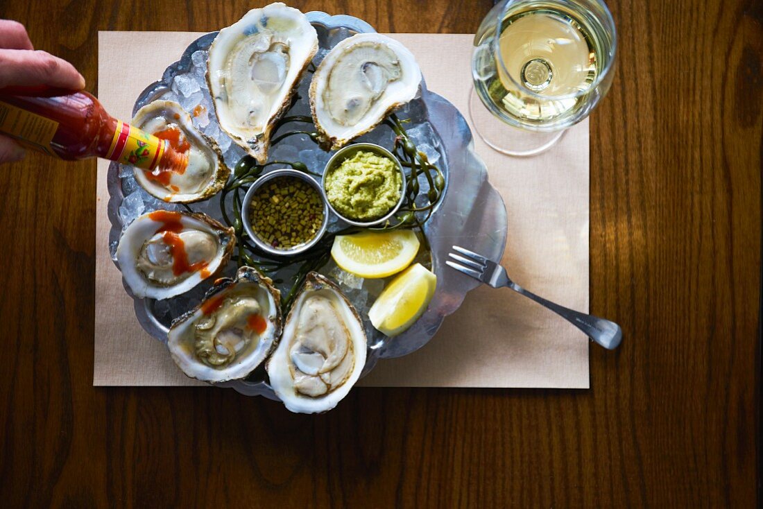 Oysters with hot sauce, lemon wedges, horseradish sauce and red wine mignonette