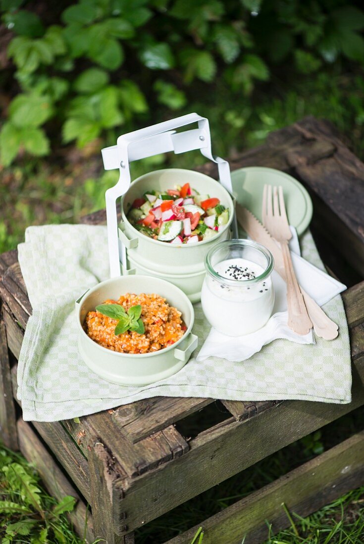 Couscous salad, tomato & cucumber salad and yoghurt dressing for a picnic