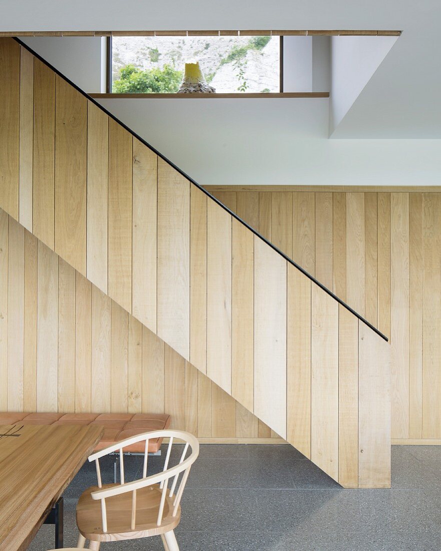 Purist, wood-clad staircase in modern interior