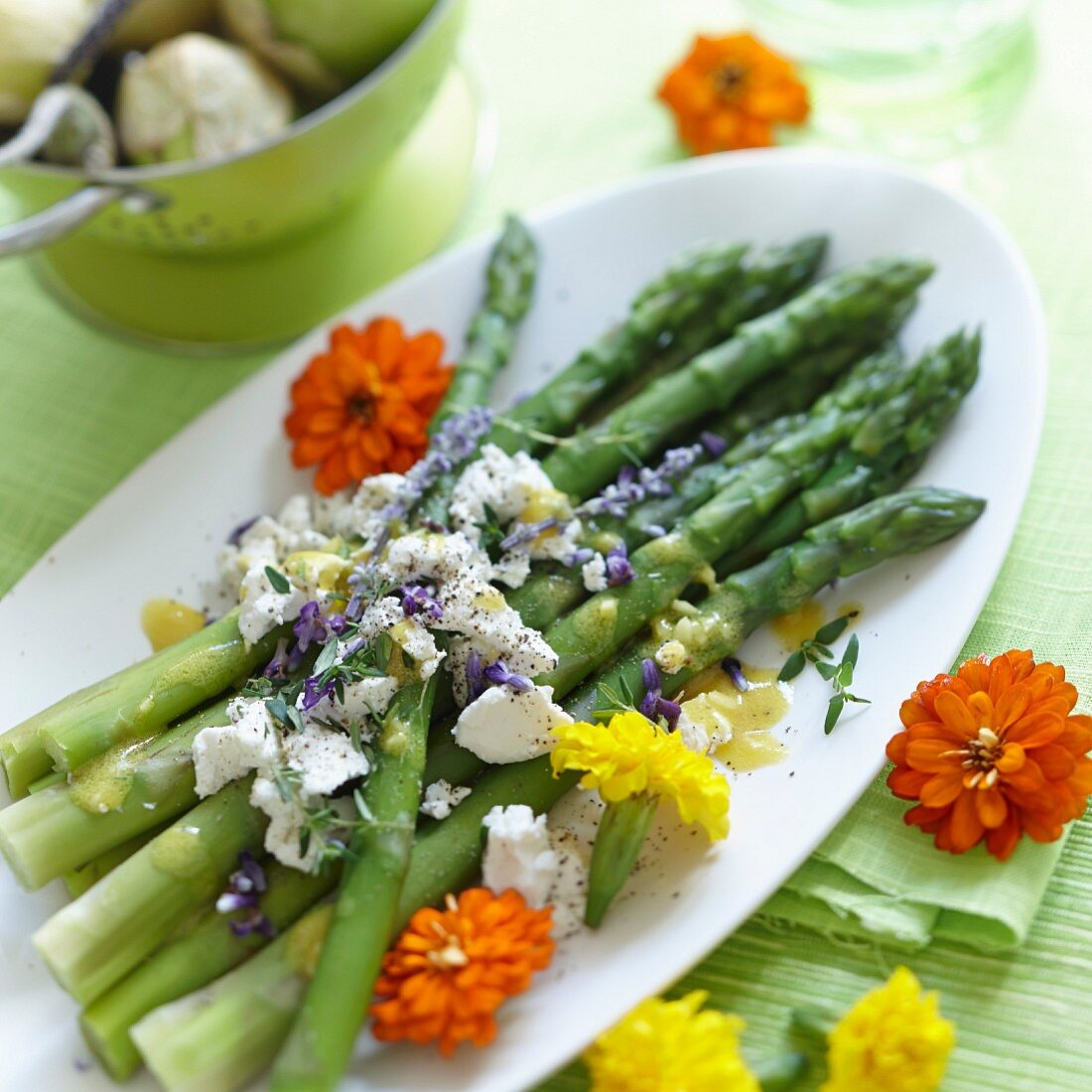 Green asparagus with cheese and edible flowers