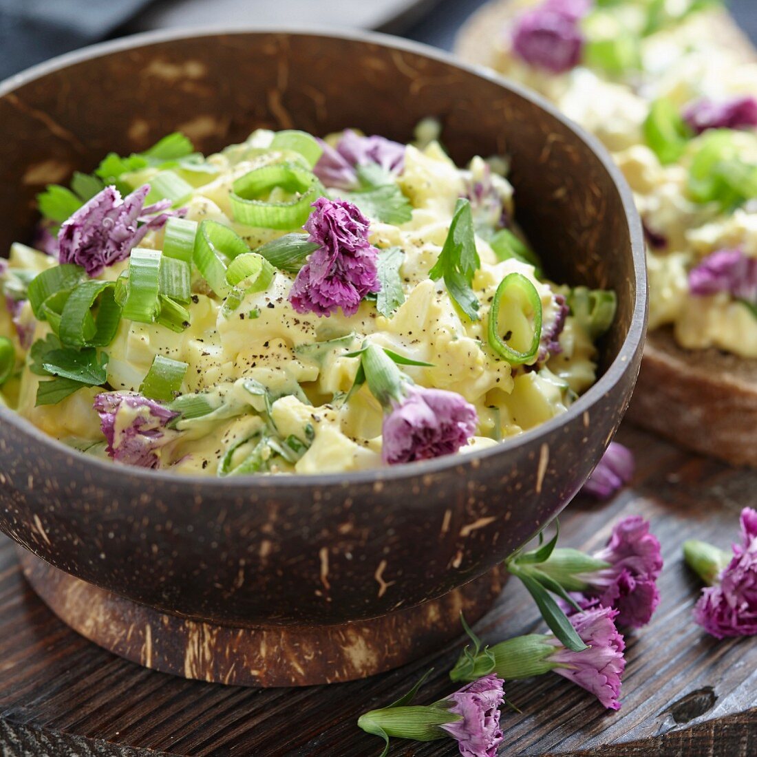 Egg salad with spring onions and purple carnations
