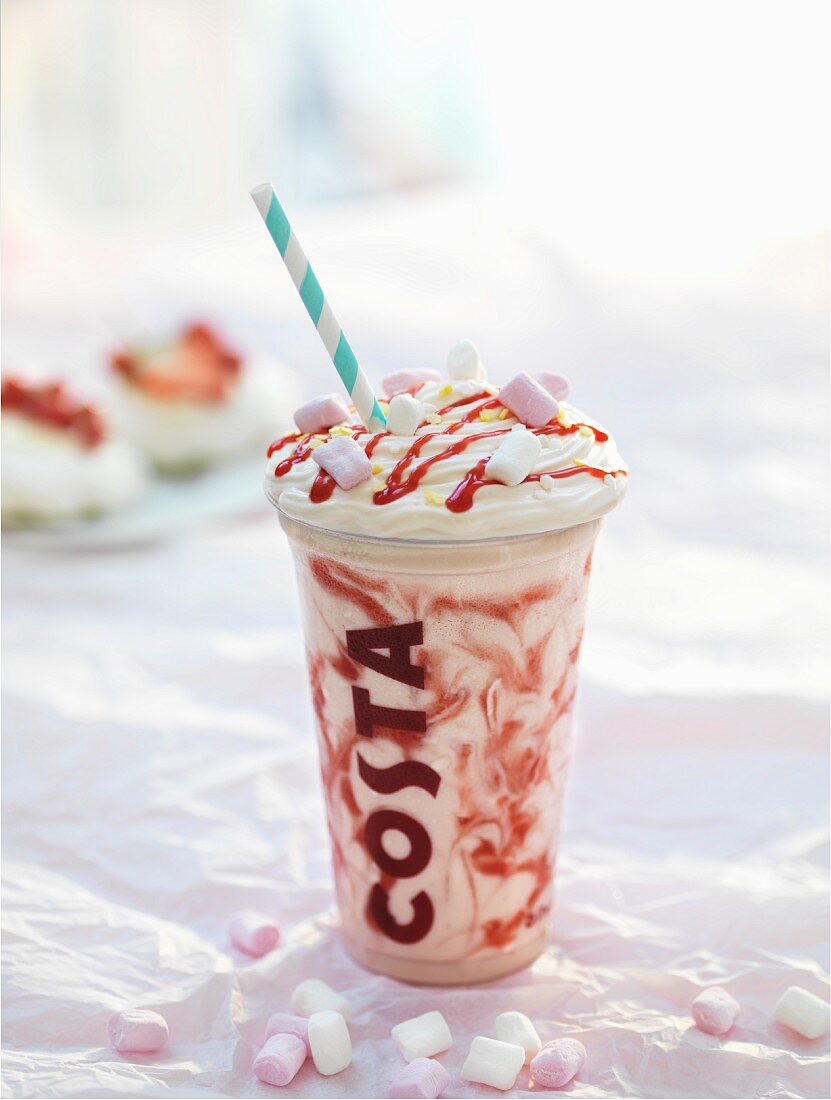 A creamy summer drink with strawberry sauce and marshmallows