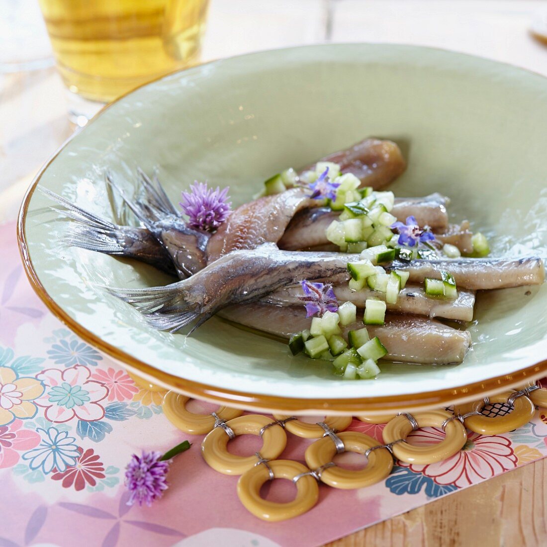 Dutch-style pickled herring with cucumber and herb flowers