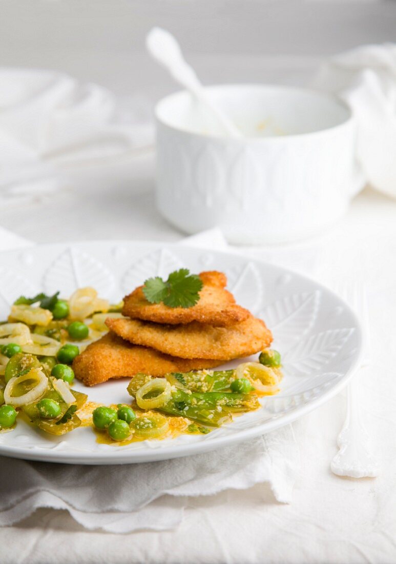 Breaded chicken breast with a pea salad