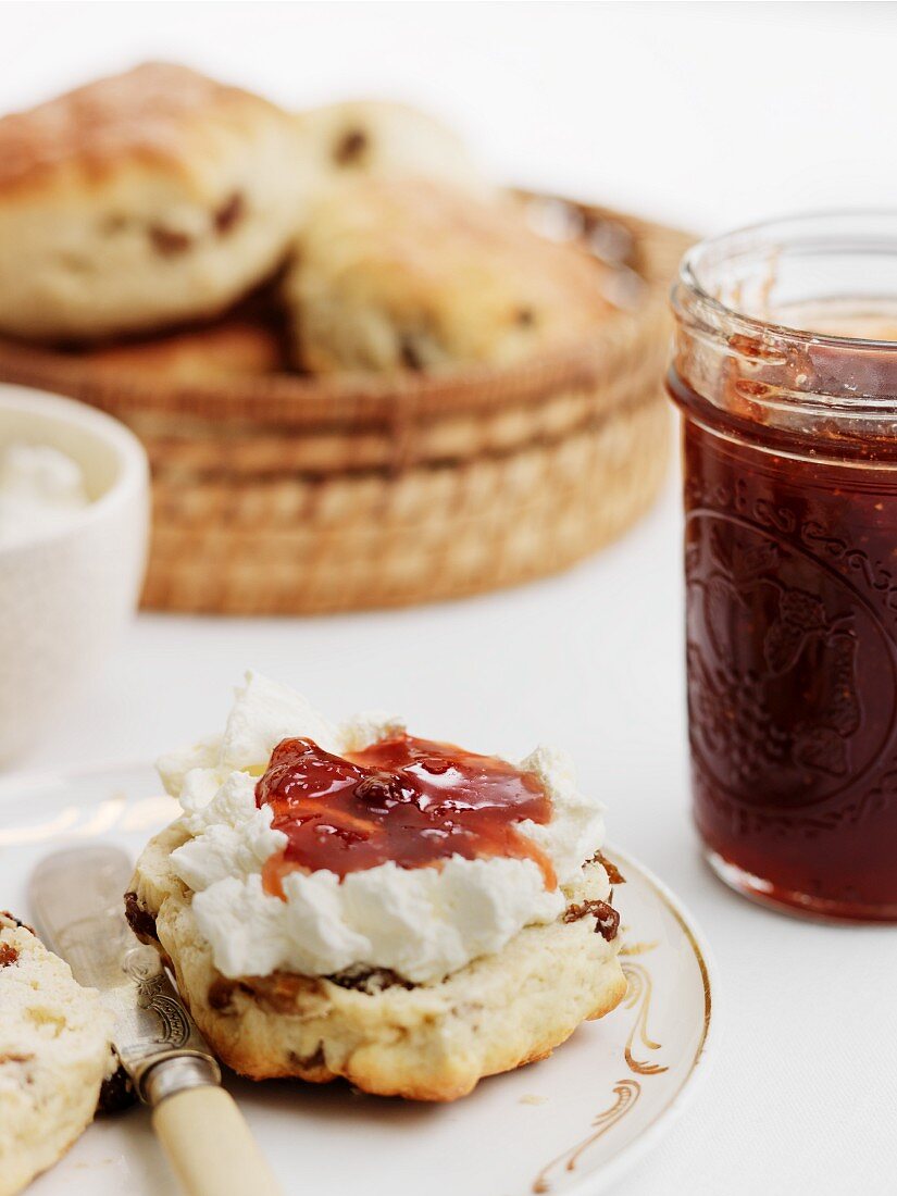 A scone with clotted cream and apple chutney