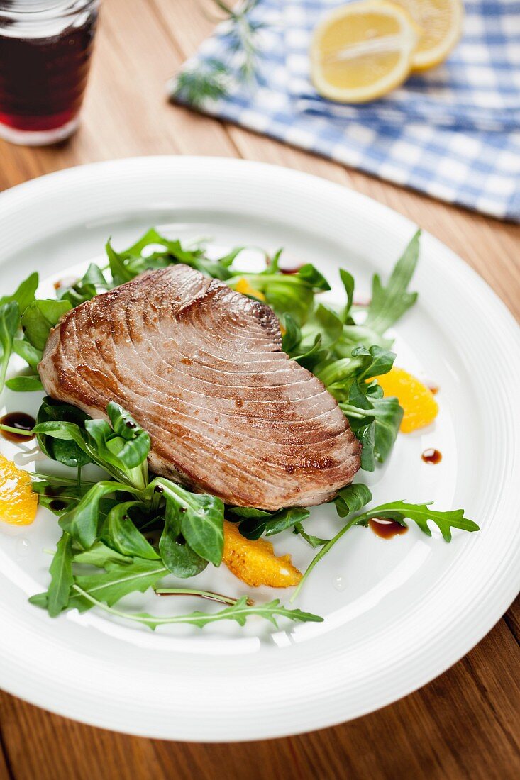 Tuna fish fillet on a rocket salad with orange fillets
