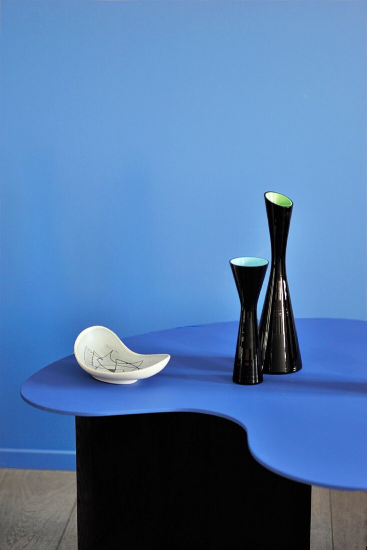 Blue designer table against partition of same colour