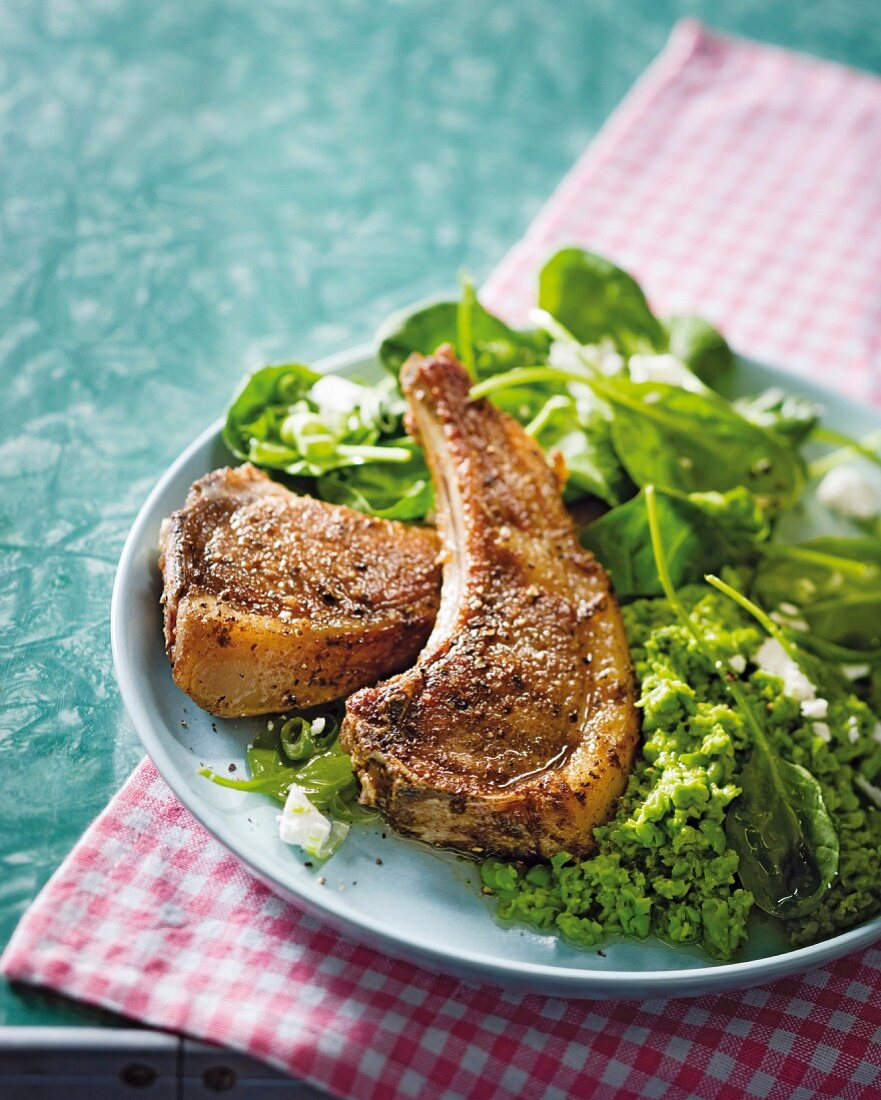 Grilled lamb chops with mint and pea puree and spinach leaves