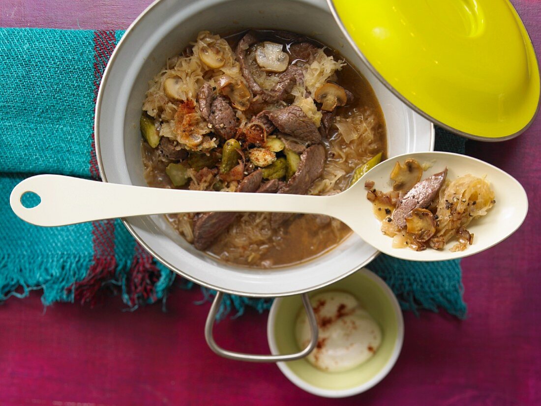 Sauerkraut stew with beef, mushrooms and gherkins