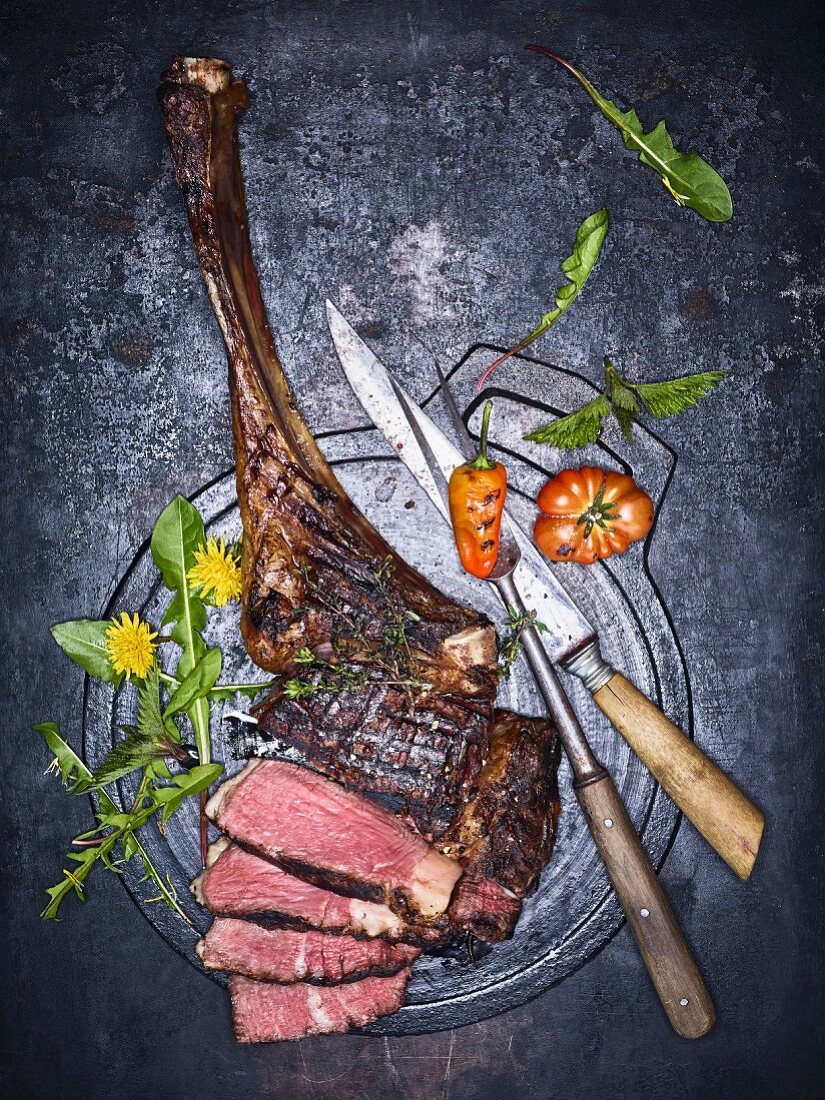 Grilled tomahawk steak, partially sliced (seen above)