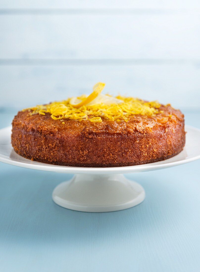 Lemon drizzle cake on a cake stand