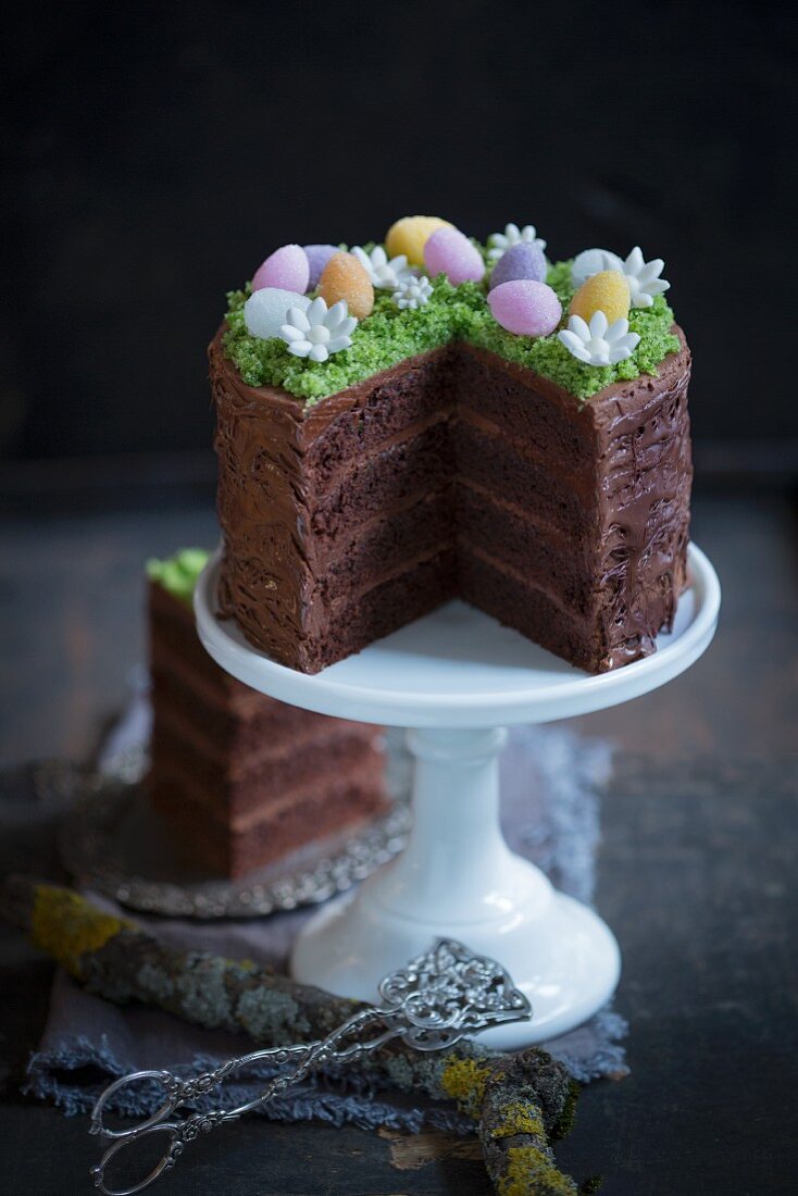 An Easter cake decorated with a chocolate glaze and sugar eggs, sliced
