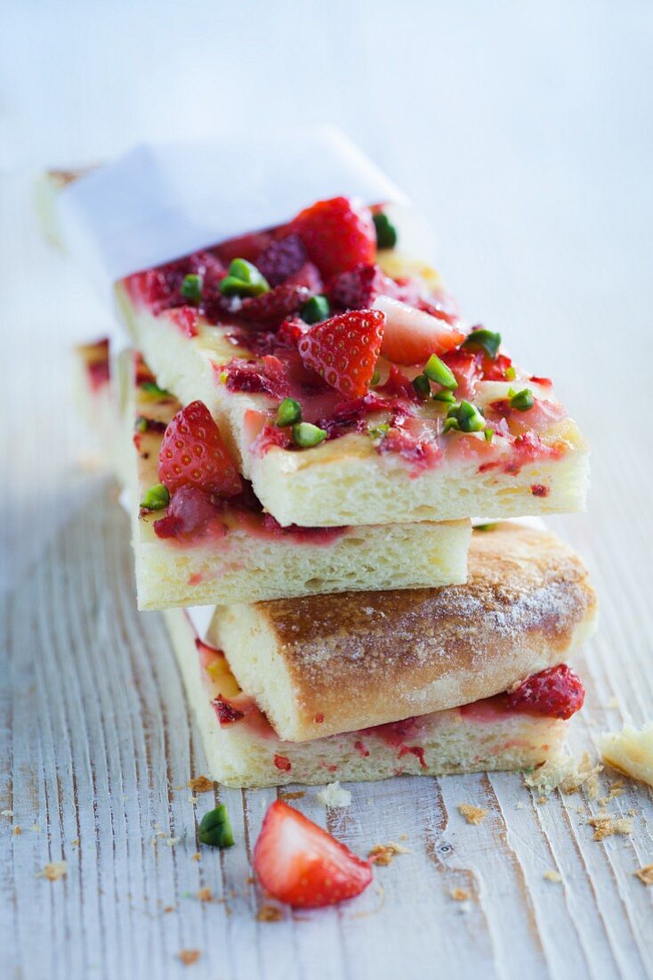 Sweet brioche pizza with strawberries and pistachios