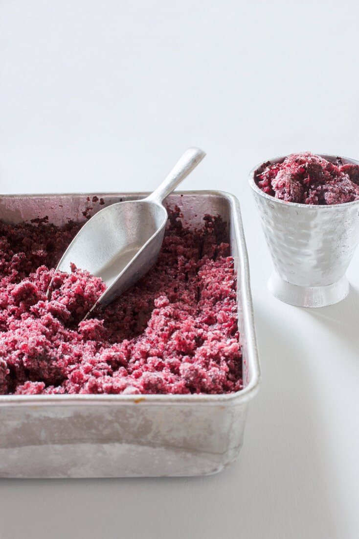 Blueberry granita in a metal tin and a metal cup