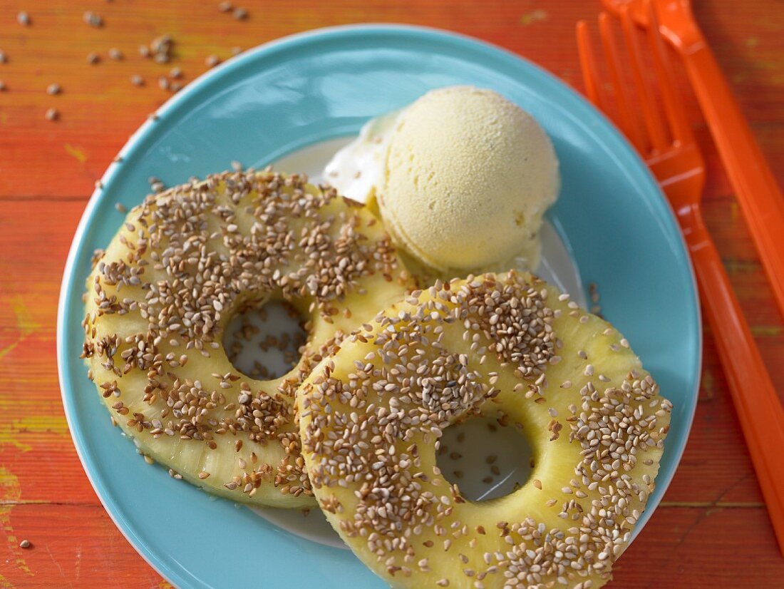 Pineapple with a sesame seed coating served with ice cream