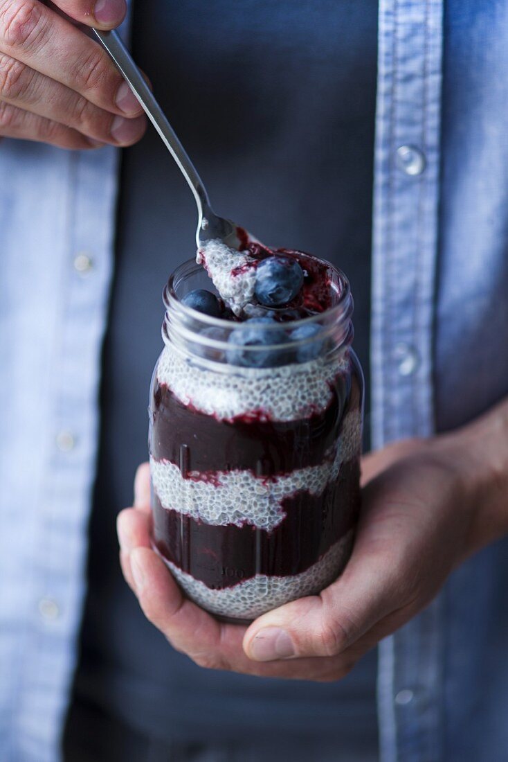 Chia pudding with blueberries layered in a screw top glass (Superfood)