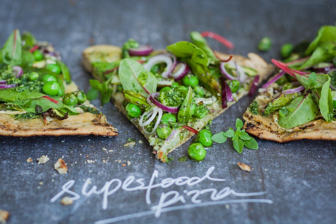 Superfood pizza with red-veined dock, peas, asparagus, and pesto