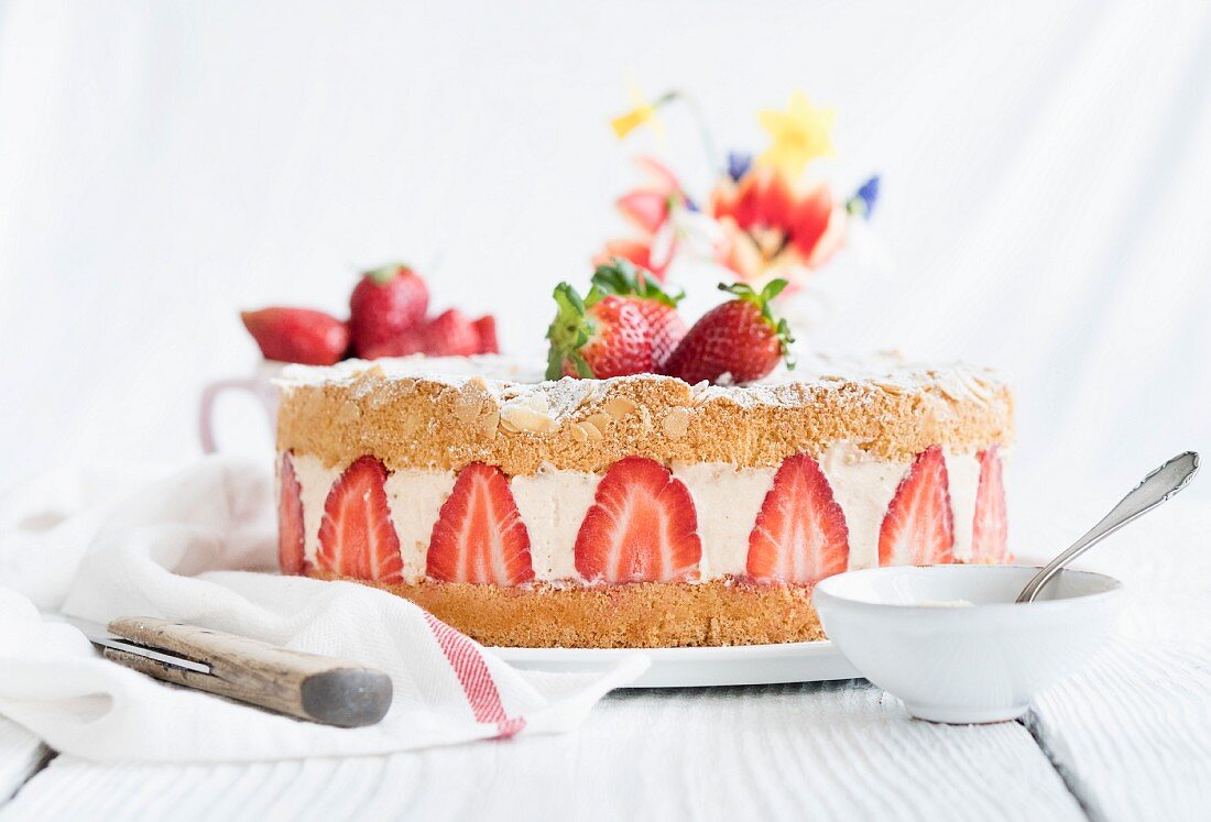 A whole strawberry cream cake on a table