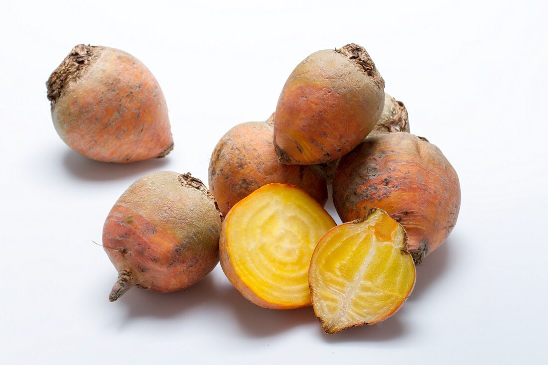 Golden beets on a white surface