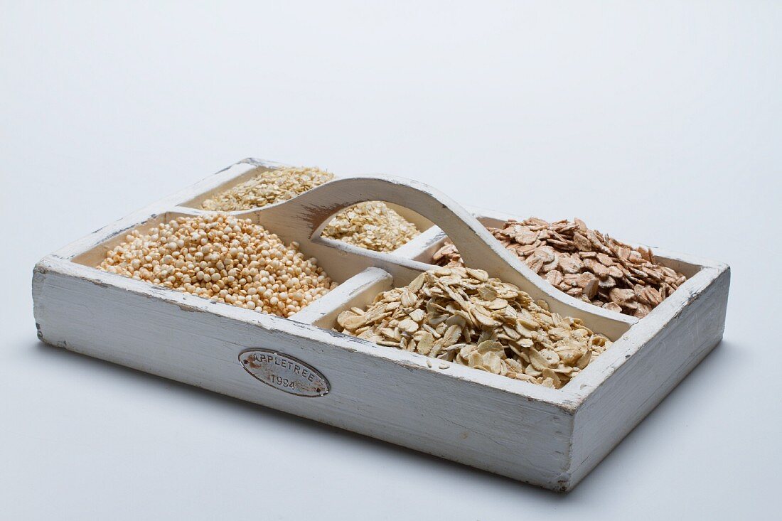 Fours types of grains on a tray with compartments