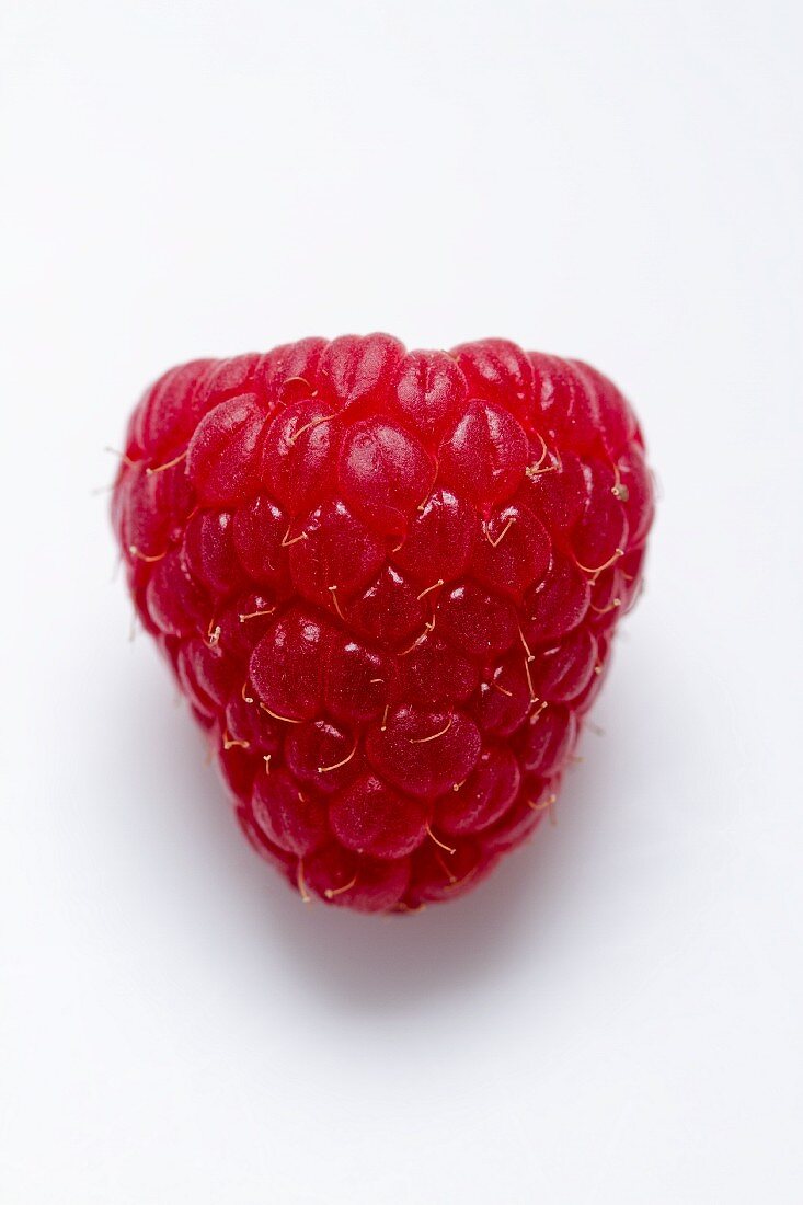 A raspberry on a white surface