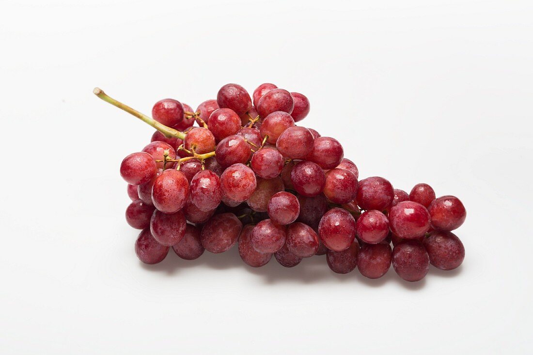 Red grapes on a white surface