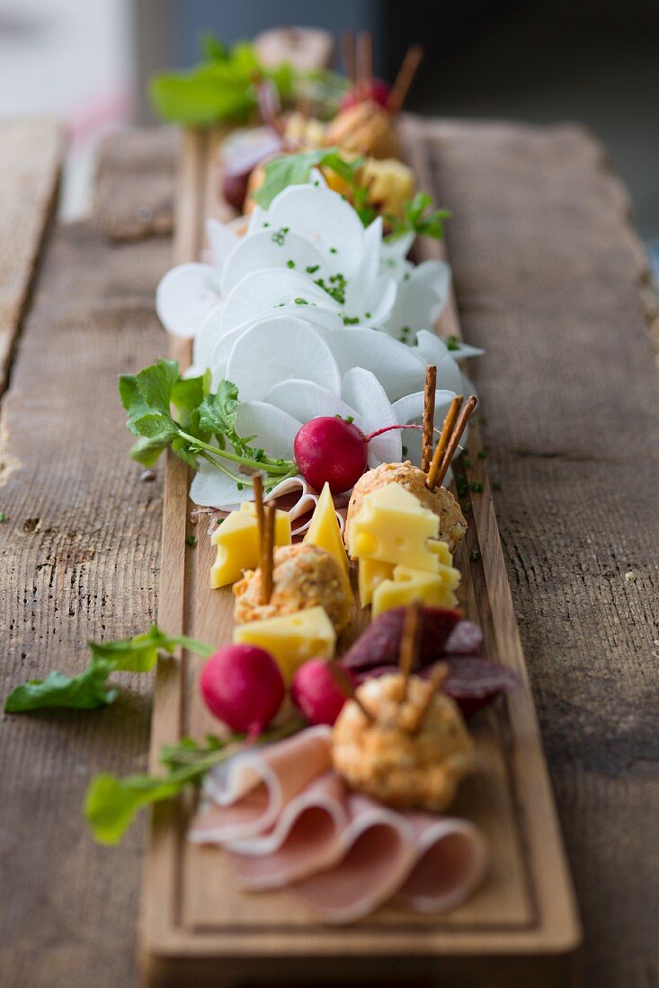 A supper board with cheese, obatzda (Bavarian cheese spread), radishes and ham at Oktober Fest